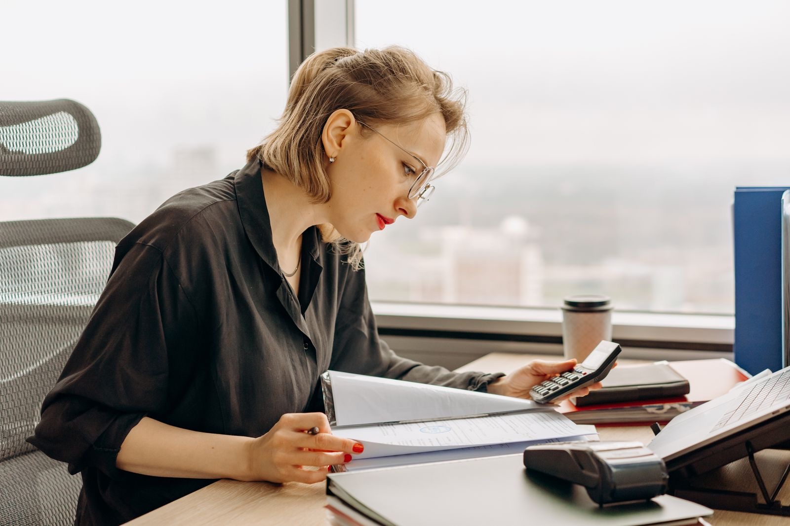 Union treasurer working through financial records at a desk