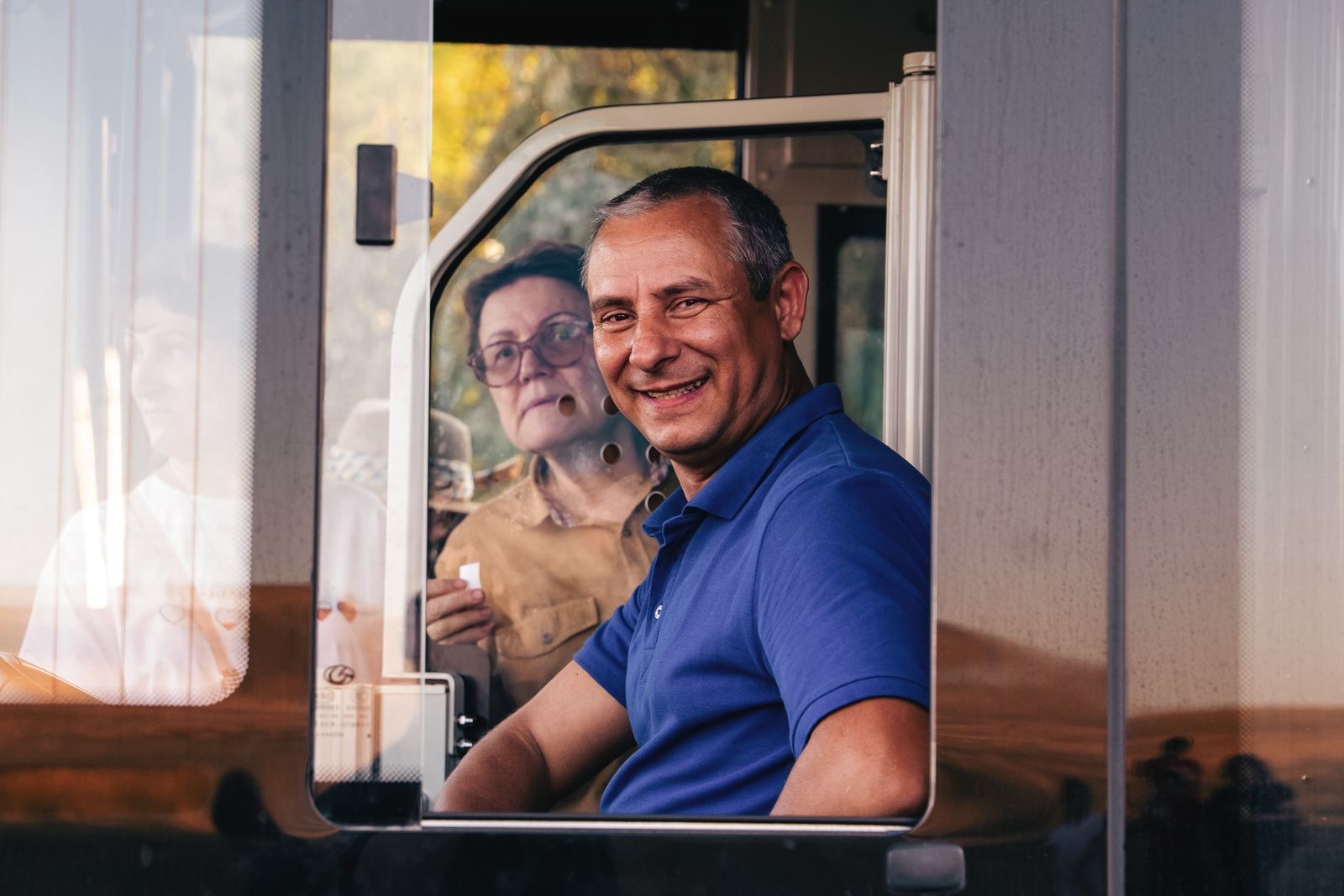 Smiling bus driver at the wheel